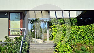 A modern residential building in the vicinity of trees.