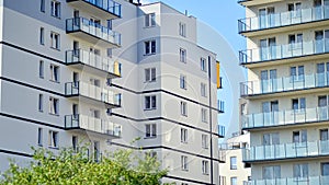 A modern residential building in the vicinity of trees.