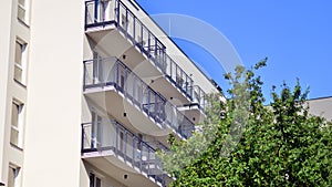 A modern residential building in the vicinity of trees.