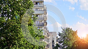 A modern residential building in the vicinity of trees.