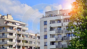 A modern residential building in the vicinity of trees.