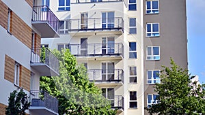 A modern residential building in the vicinity of trees.