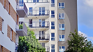 A modern residential building in the vicinity of trees.