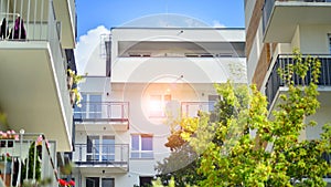 A modern residential building in the vicinity of trees.