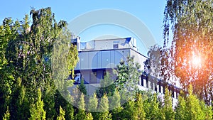 A modern residential building in the vicinity of trees.