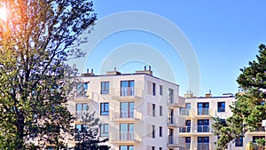 A modern residential building in the vicinity of trees.