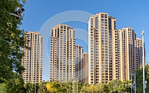 Modern residential complex with tall houses against the blue sky