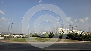 Modern residential construction site with crane and houses under clear sky