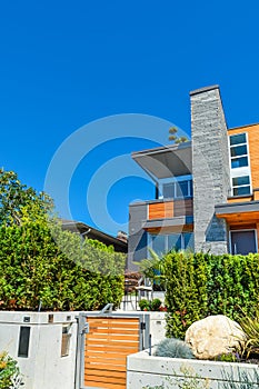 Modern residential house with concrete terrace and wooden gate