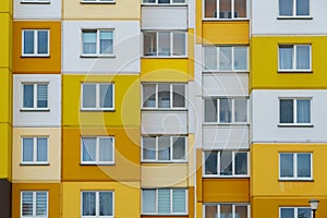 Modern residential multi-storey building. Windows and balconies on a new residential building close-up. Buying and selling