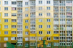 Modern residential multi-storey building. Windows and balconies on a new residential building close-up. Buying and selling