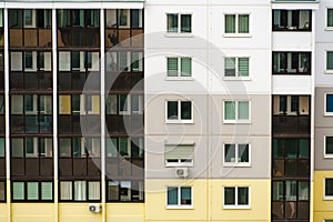 Modern residential multi-storey building. Windows and balconies on a new residential building close-up. Buying and selling