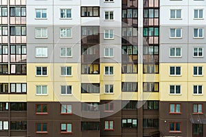 Modern residential multi-storey building. Windows and balconies on a new residential building close-up. Buying and selling