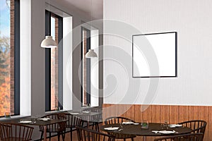 Modern restaurant interior with served tables and blank poster