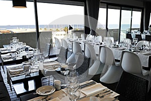 Modern Restaurant with Ocean View, White Napkins, Elegant Table Set
