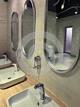 Modern restroom interior with stone gray tiles. interior of public toilet.