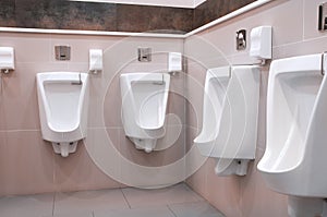 Modern restroom interior with urinal row