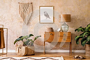 Modern retro composition of living room with wooden vintage commode, furniture, lamp, plant, carpet, pillows, gold mock up poster