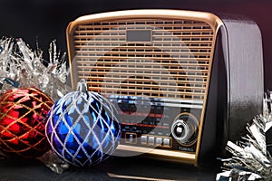 Radio receiver in retro style with christmas decorations on black background