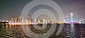 Modern riverside building illuminated at night,