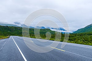 Modern road through Alaska wilderness