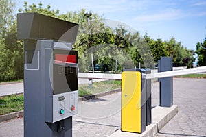 Modern road barriers and parking meter outdoors on sunny day