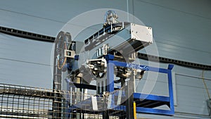 Modern robotic machine transports blue detail at plant