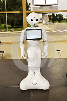 Modern Robotic Technologies. Electronics Show-exhibition of consumer electronics. The robot shows emotion. Raises hands upward,