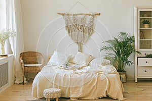 Modern romantic boho style bedroom interior with macrame wall panel