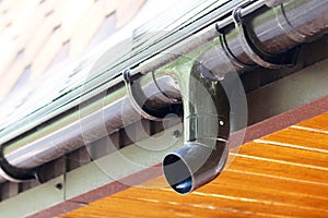 Modern roof of house with plastic rain gutter