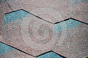 Modern roof shingles tiles, close up. Soft asphalt roof cover. New roofing construction. Easy roofing repair