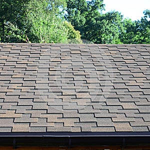 Modern roofing and decoration of chimneys. Flexible bitumen or slate shingles