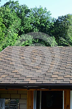 Modern roofing and decoration of chimneys. Flexible bitumen or slate shingles