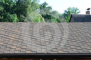 Modern roofing and decoration of chimneys. Flexible bitumen or slate shingles