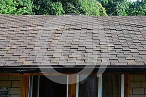 Modern roofing and decoration of chimneys. Flexible bitumen or slate shingles