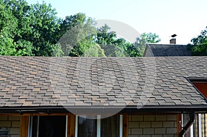 Modern roofing and decoration of chimneys. Flexible bitumen or slate shingles