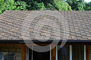 Modern roofing and decoration of chimneys. Flexible bitumen or slate shingles