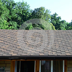 Modern roofing and decoration of chimneys. Flexible bitumen or slate shingles