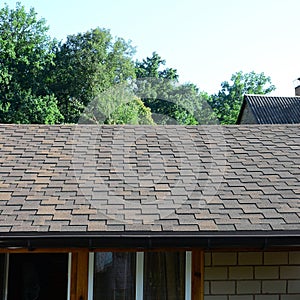 Modern roofing and decoration of chimneys. Flexible bitumen or slate shingles