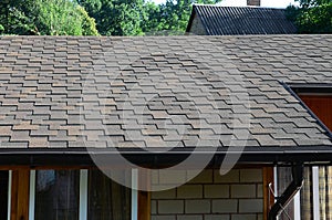 Modern roofing and decoration of chimneys. Flexible bitumen or slate shingles