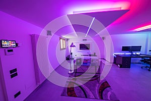 Modern room with bight led strips light. Tv, monitor and sofa