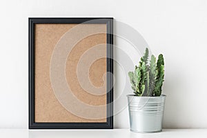 Modern room decoration. Cactus plant in white flower pot. Mock-up poster.