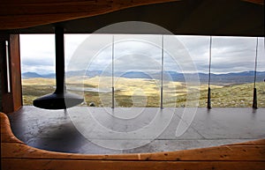 Modern room with a fireplace and view on mountain