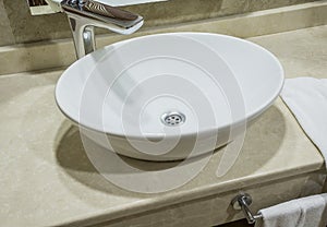 Modern round washbasin in apartament or in hotel photo