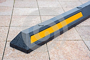 Modern rubber barrier for cars in summer parking in the street