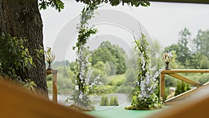 Modern rustic natural wedding arch of green foliage and flowers