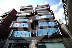 Modern rusty Ironbank with piled up boxes and glass windows. Mixed-used development on Karangahape Road, Auckland, New Zealand    