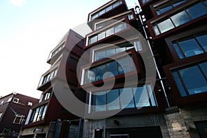 Modern rusty Ironbank with piled up boxes and glass windows. Mixed-used development on Karangahape Road, Auckland, New Zealand