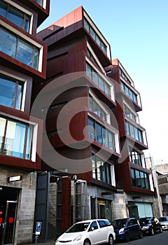 Modern rusty Ironbank with piled up boxes and glass windows. Mixed-used development on Karangahape Road, Auckland, New Zealand