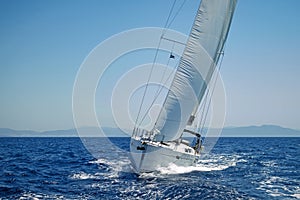 Modern sailing yacht in action photo